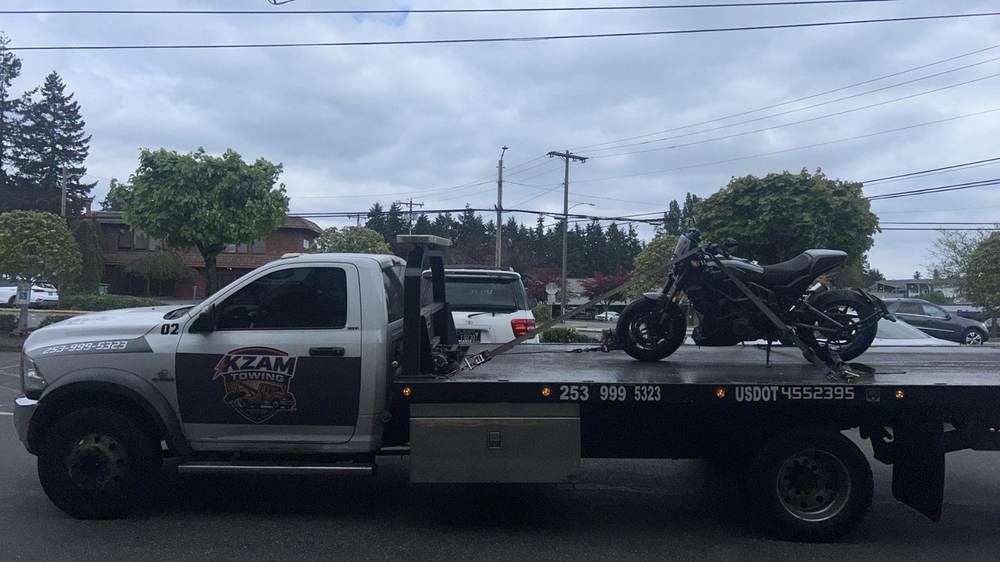 KZAM flatbed carrying a motorcycle